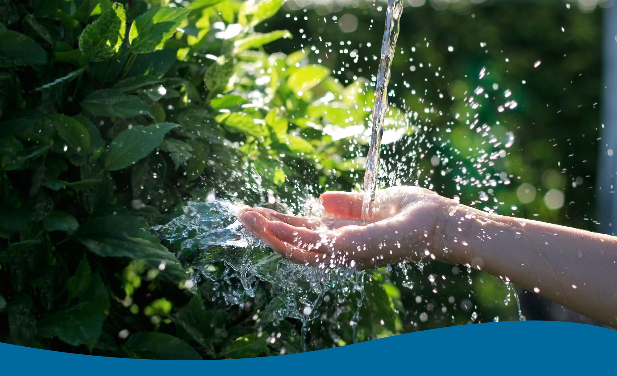 Hand catching water pouring