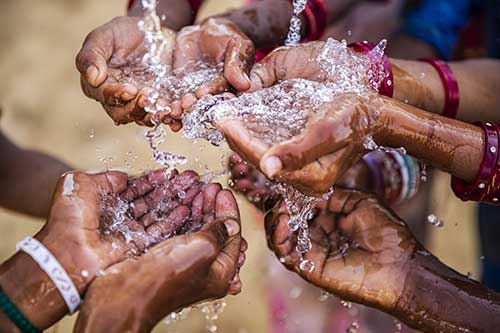 Hands cupping water.